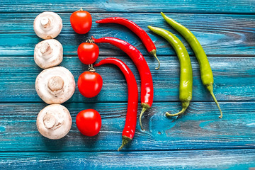 Colorful pizza ingredients pattern made of cherry tomatoes, mushroms and pepper on white background. Cooking concept.