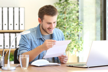 Happy entrepreneur reading a letter