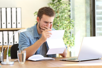 Worried entrepreneur reading a letter