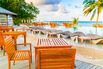Table and chairs at restaurant in tropical Maldives island .