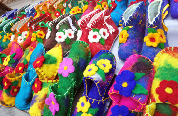 Fototapeta na wymiar Handmade colorful wool slippers or shoes for sale at street in Tbilisi, Georgia