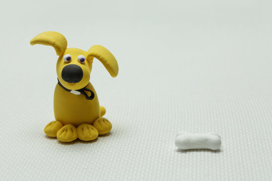 Dog and a bone from plasticine
