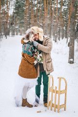 Beautiful couple embracing. The couple walking in the Park in winter.