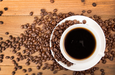 Cup of coffee, roasted coffee beans. Top view