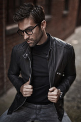 Leather jacket guy in spectacles, looking away