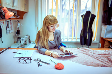 Fashion designer looking at sketches in studio