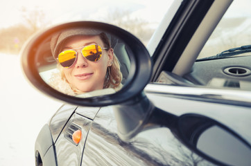 Hipster woman sitting in a small car