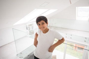 Fototapeta na wymiar Cute boy in new modern property home interior