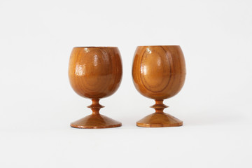 Wood made two glasses of water placed on a white background.