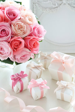 Bouquet of beautiful pink roses with gifts on  the table,Romantic style