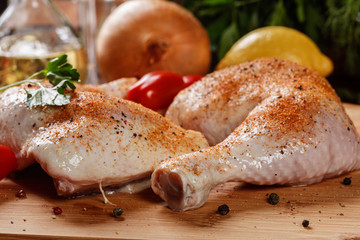 Raw chicken drumsticks seasoned with herbs