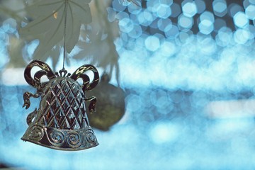 Christmas silver bell and ball ornament on artificial white tree