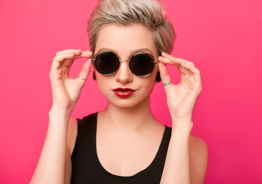 closeup beautiful trendy hipster girl in retro sunglasses