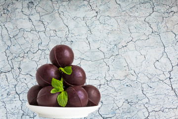 Chocolate sweets - darl brown balls - decorated with mint leaves