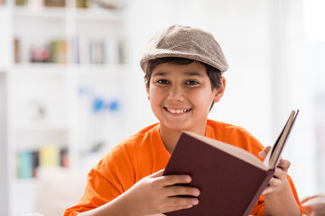 Kid with book at home