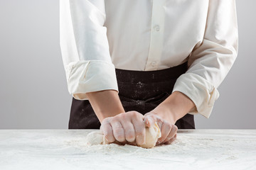 Hands kneading a dough