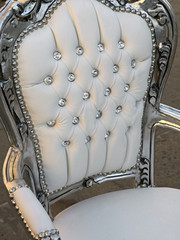 Fototapeta na wymiar precious ancient chair in white leather and diamond buttons