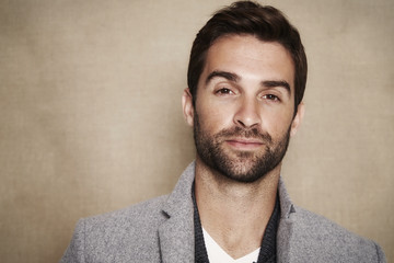 Portrait of handsome man in grey coat