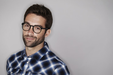 Portrait of man in checked shirt, smiling