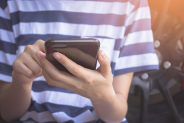 hand working smartphone and morning light. vintage effect