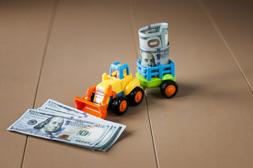toy tractor with money on table