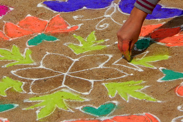 Close-up of rangoli ,a Hindu Decoration with colored powders,flowers,cow dung etc in all festivals,events,functions as a tradition being drawn