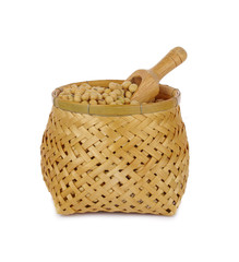 Soy beans with wooden scoop in bamboo basket