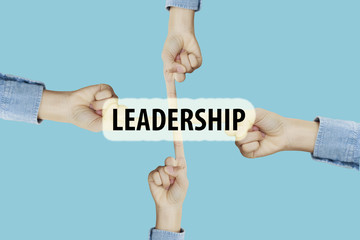 Many hands fingers pointing with index fingers to LEADERSHIP tex