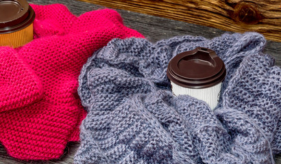Paper cups of coffee with scarves.