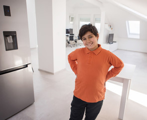 A boy standing in new modern kitchen