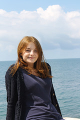 happy girl on background of blue sky and sea