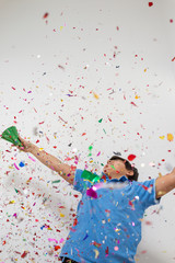 Happy kids celebrating party with blowing confetti