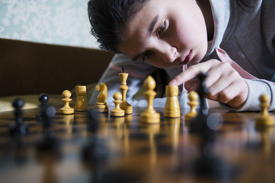 teen girl making checkmate playing chess