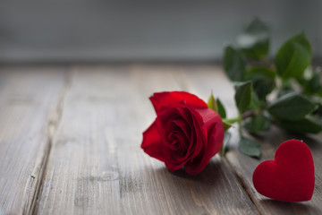 Rose and heart of fabric on a vintage background toned