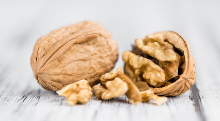 Portion of Whole Walnuts on wooden background (selective focus)