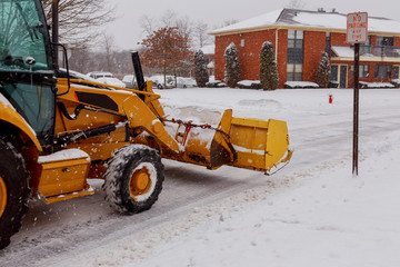 Snow plow doing removal after a blizzard