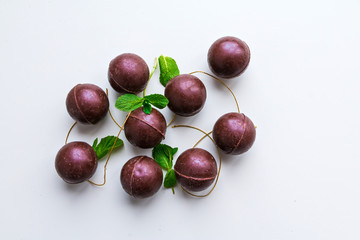Chocolate sweets - dark brown balls - decorated with mint leaves