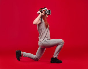 Woman using the virtual reality headset on red