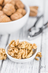 Cracked Walnuts on wooden background (selective focus)