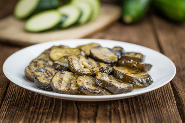 Zucchinis (grilled) on wooden background (selective focus)