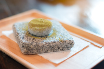 Green tea mo chi on stone plate; japanese cuisine.