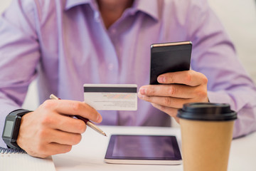 Man holding tablet pc and credit card indoor, Shopping Online. 