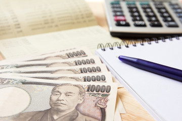 Saving account passbook, japanese yen, note book, calculator and