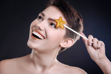 Obraz premium Joyful woman posing with lollipop