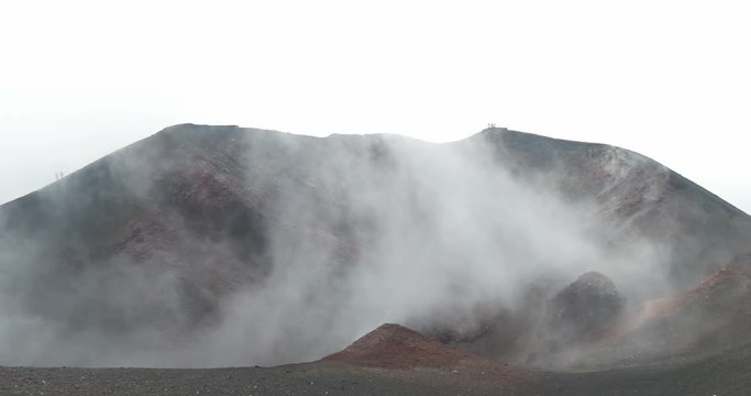 Tourist in the lunar scenery on the summit crater of Etna volcano, Italy