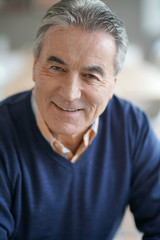 Portrait of senior man with blue sweater looking at camera