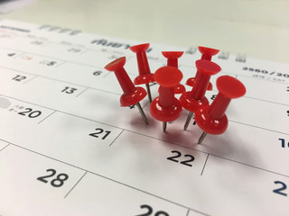 Thumbtack in calendar concept for busy, appointment and meeting reminder