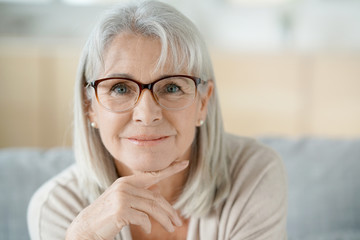 Portrait of senior woman with eyeglasses - obrazy, fototapety, plakaty