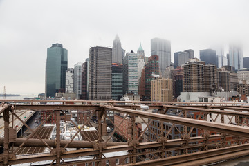 Fototapeta na wymiar Views across the bridge walking the Brooklyn Bridge in New York