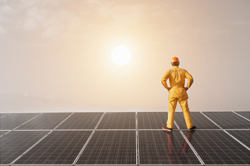 Engineer standing looking at the sun as a source of clean energy